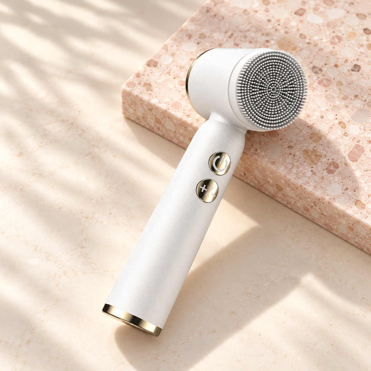 Facial cleansing brush on a blush studio background